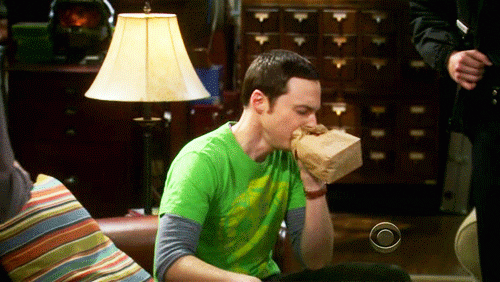 A GIF of Sheldon from the Big Bang Theory hyperventilating and breathing into a paper bag.